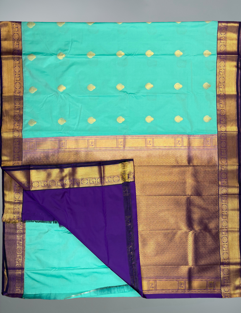 Sea Green Semi Silk Saree with Contrast Royal Purple Zari Border & Gold Chakram Motifs